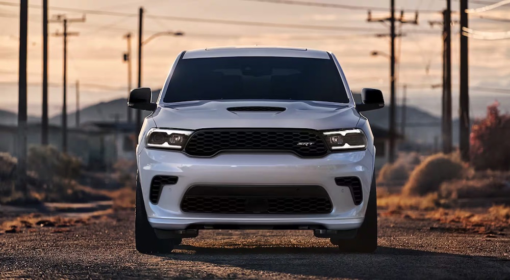 A front view of a white 2024 Dodge Durango SRT leaving a dealer with a Dodge Durango for sale.