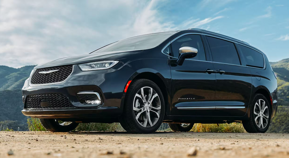 A black 2024 Chrysler Pacifica Pinnacle parked in the mountains.