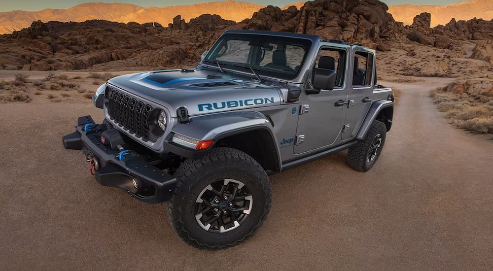 A silver 2024 Jeep Wrangler Rubicon parked off-road in a desert.