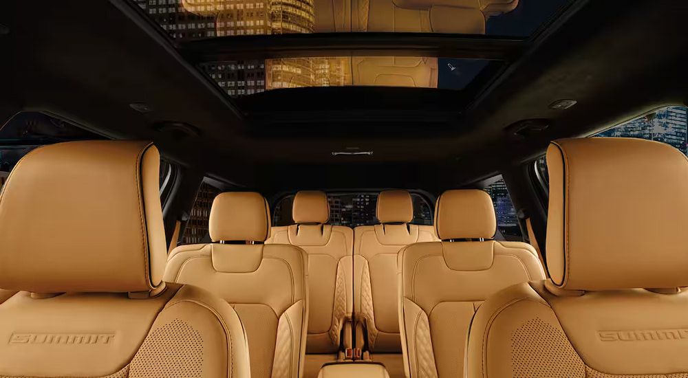Three rows of tan leather seating in a 2024 Jeep Grand Cherokee L Summit.