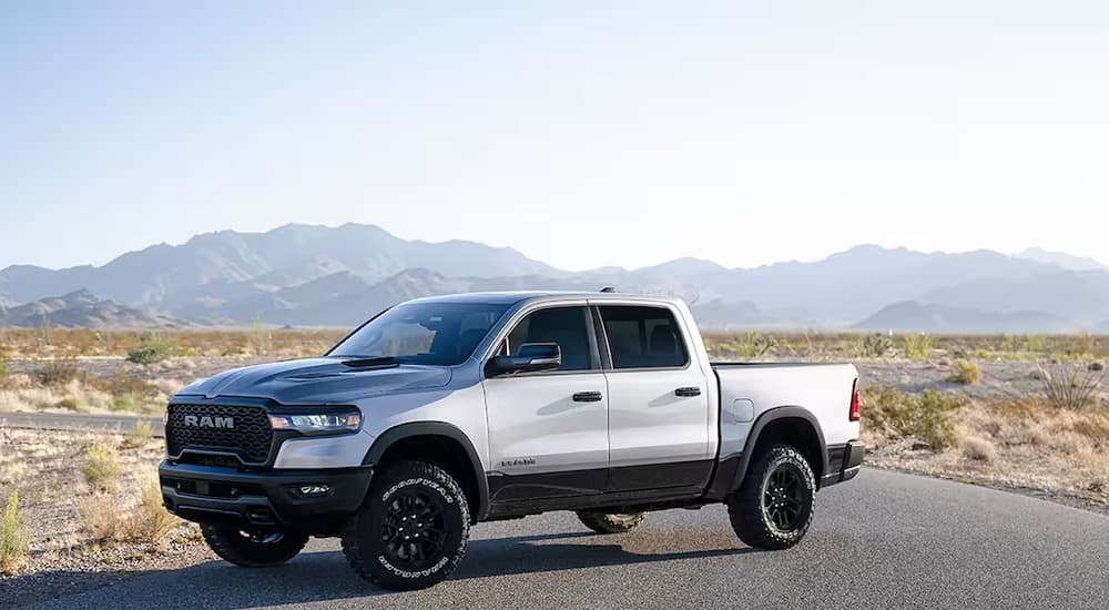 A silver 2025 Ram 1500 Rebel is shown from the side after leaving a Ram dealer.