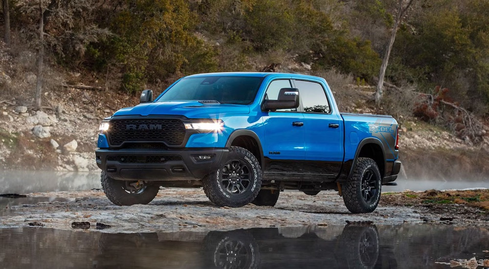 A blue 2025 Ram 1500 Rebel is shown from the side.