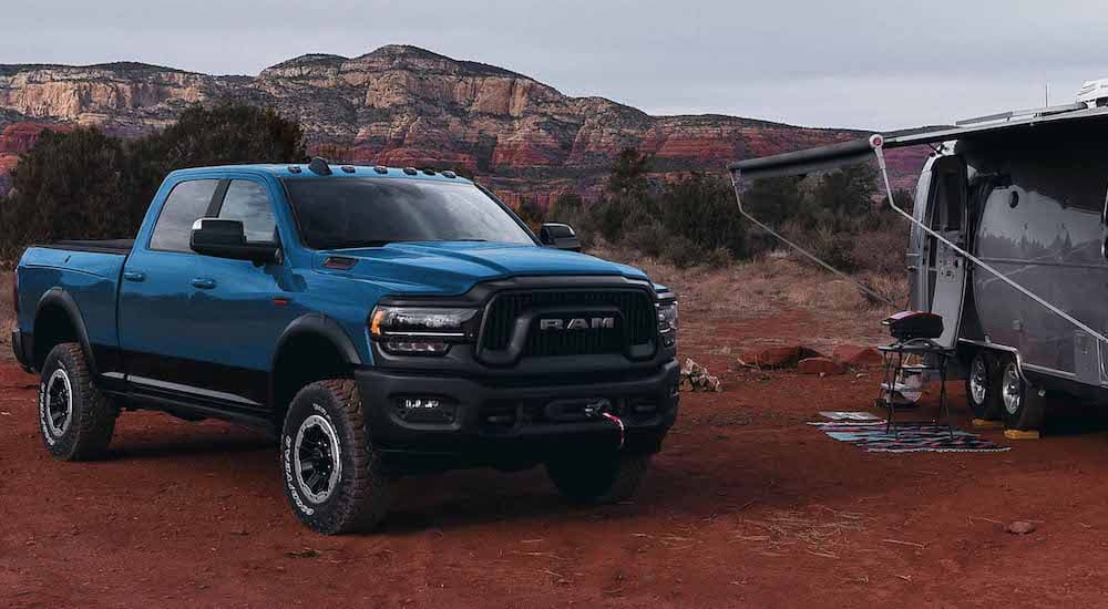 A blue 2025 Ram 2500 HD Power Wagon is shown from the front at an angle.