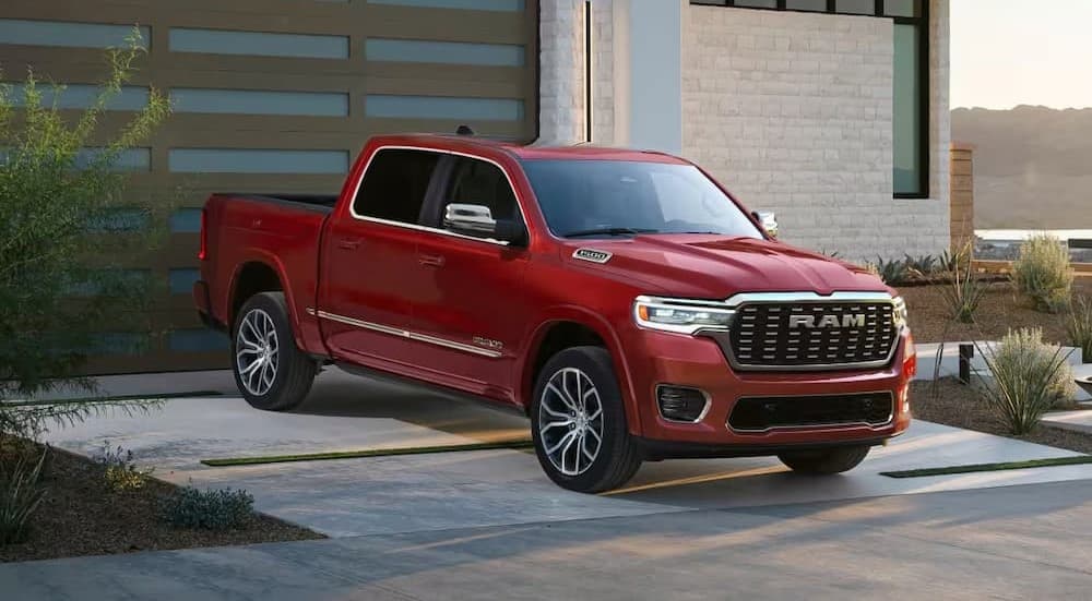 A red 2026 Ram 1500 for sale parked on a driveway.