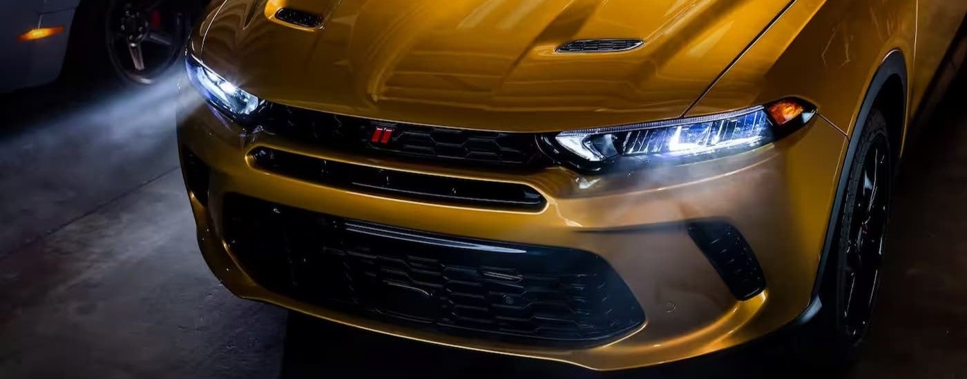 Close-up on the hood and headlights of a yellow 2024 Dodge Hornet.