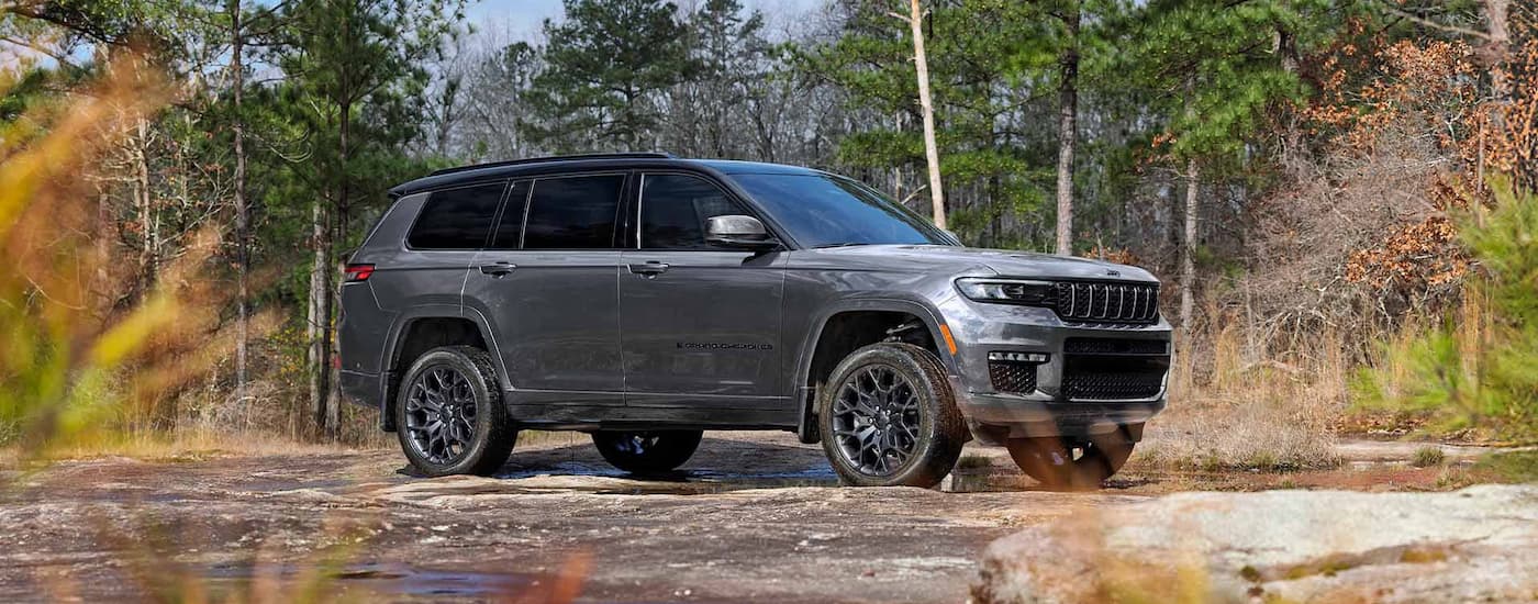 Grey 2025 Jeep Grand Cherokee parked on a rock