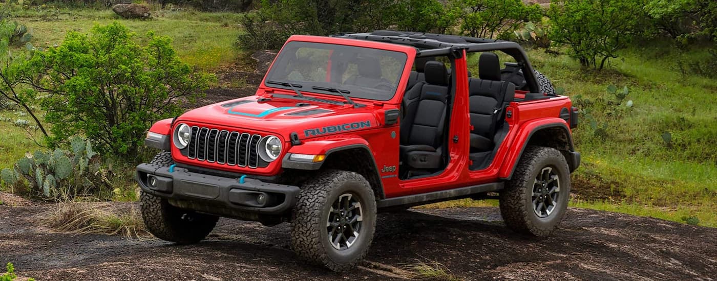 Red 2025 Jeep Wrangler Rubicon for sale near Decatur driving off-road.