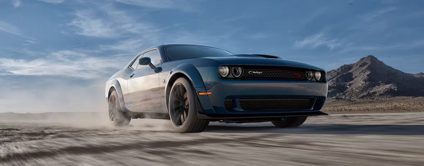 A blue 2023 Dodge Challenger Scat Pack Widebody is shown from the front at an angle after leaving a used Dodge dealer.