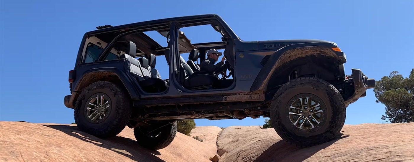 A grey 2024 Jeep Wrangler Rubicon X is shown from the side.