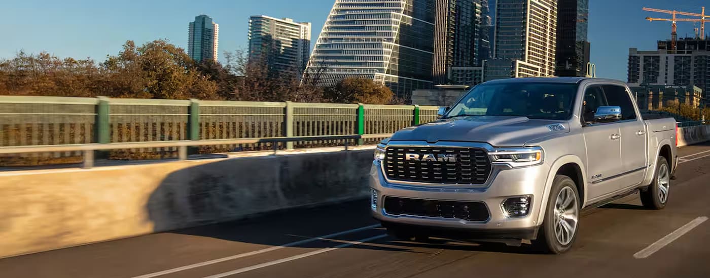 Grey 2025 Ram 1500 driving on a highway to a Ram dealer near Bloomington