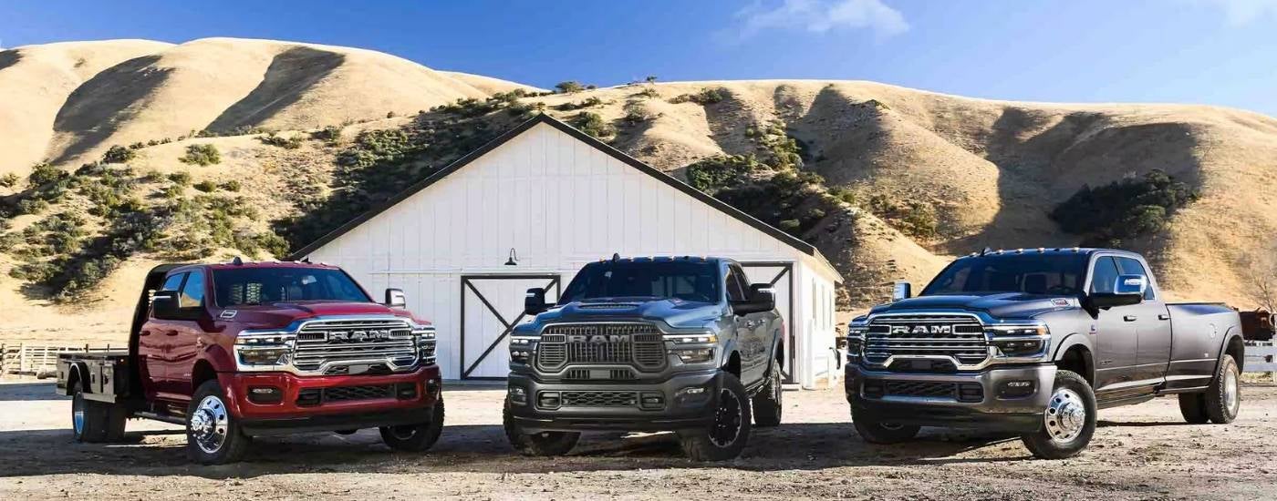 Three 2025 Ram 2500s parked at a Ram dealer near Peoria.