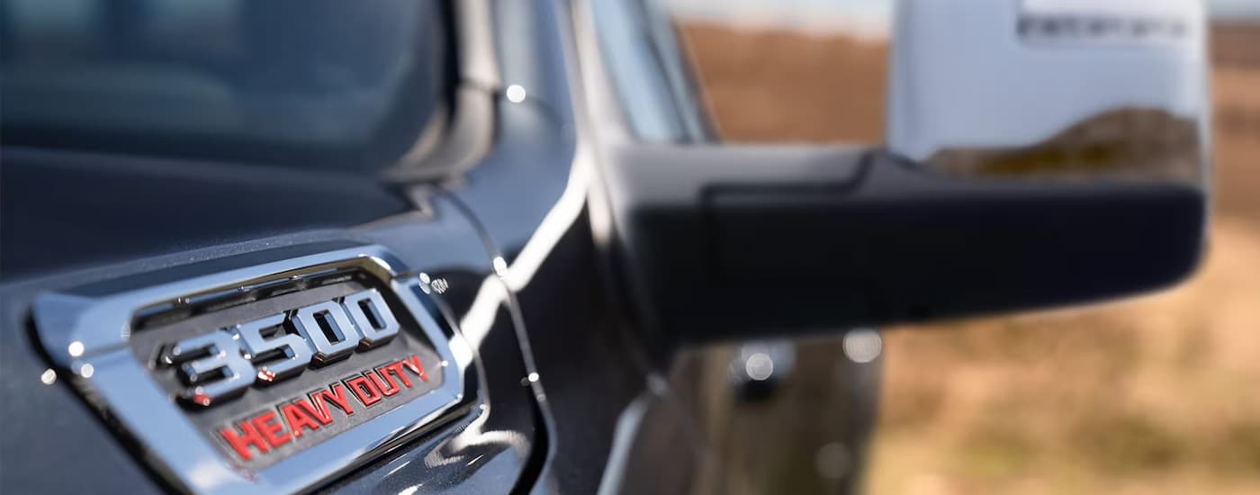 The hood badge on a black 2025 Ram 3500 at a Ram dealer near Springfield.
