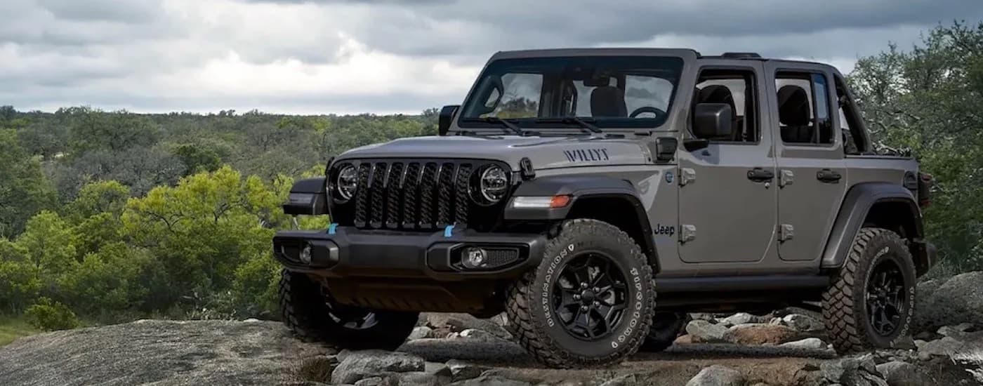 A grey 2023 Jeep Wrangler Willys 4xe is shown from the front at an angle.