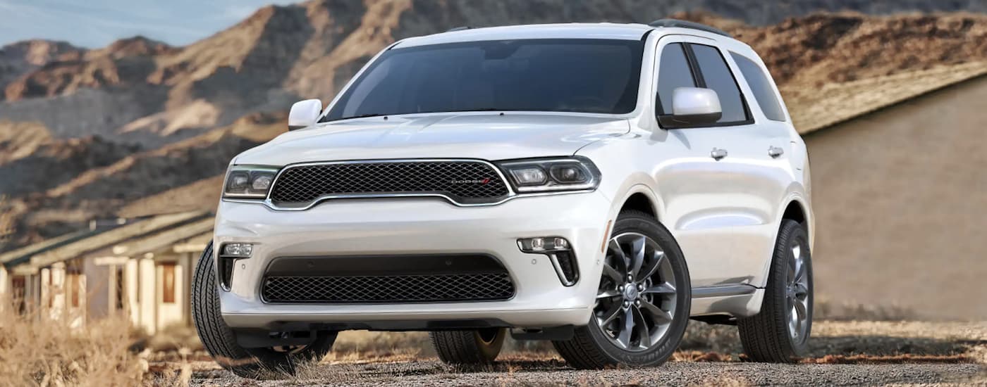 A white 2020 Dodge Durango parked in front of mountains.