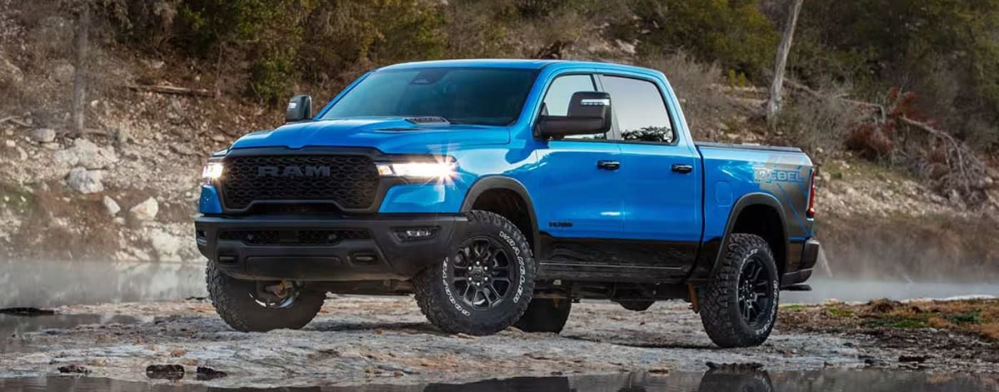 A blue 2025 Ram 1500 parked off-road